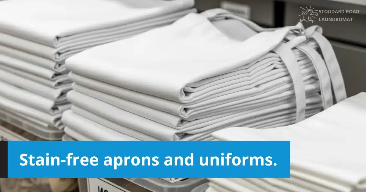 Neatly folded white aprons stacked after professional washing.
