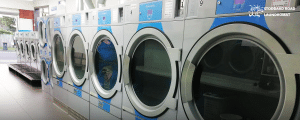 Row of commercial washing machines at Stoddard Road Laundromat, Auckland.